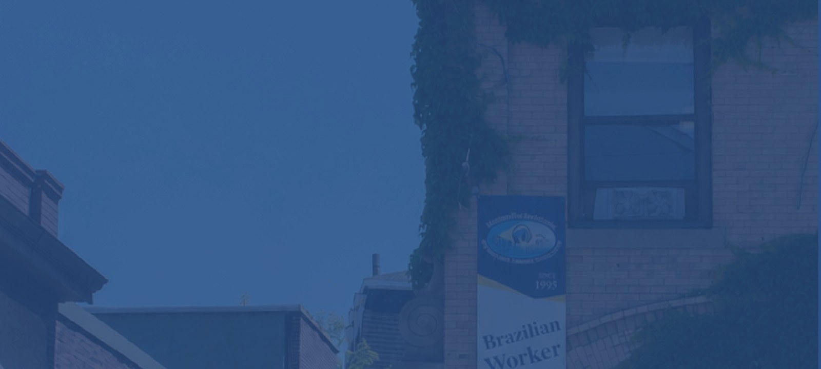 The Brazilian Worker Center building on Harvard Avenue in Allston, Massachusetts, with people passing by